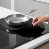 Lifting the induction mat to reveal scratch-free glass