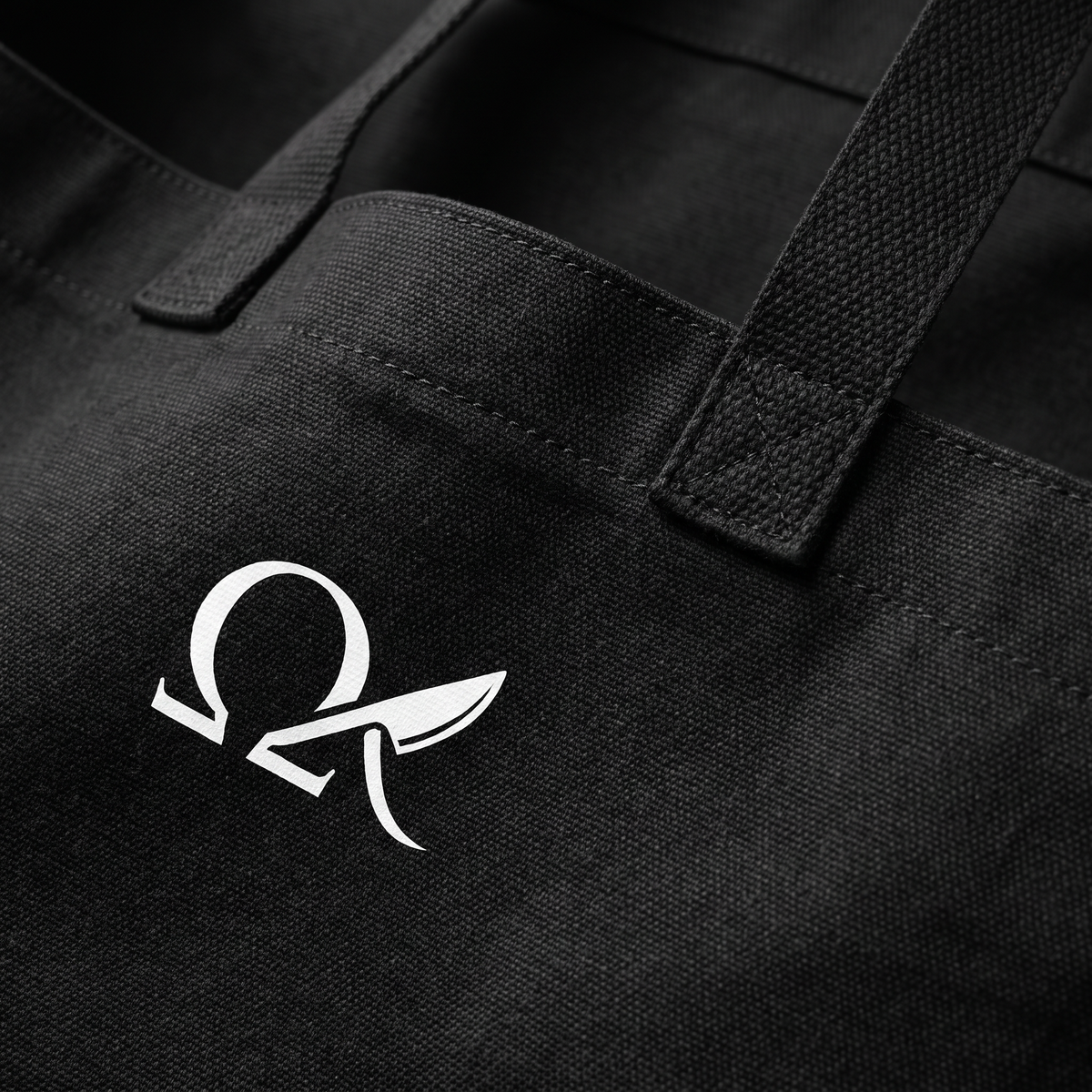 Close-up of the OMEGA logo and heavy-duty black canvas