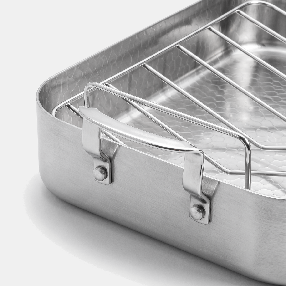 Roasting pan corner detail - riveted handle, rack and hammered titanium interior